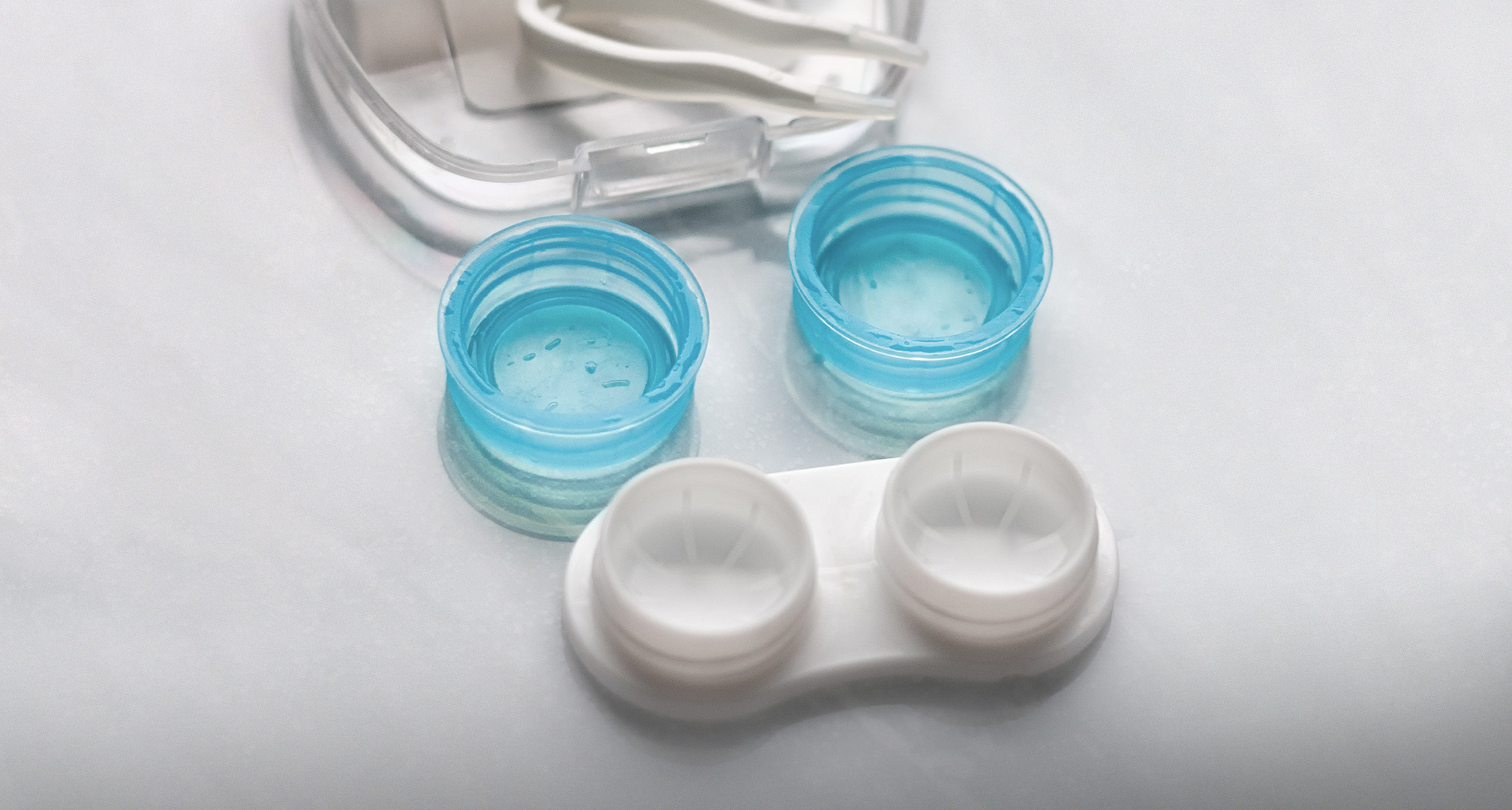 empty contact lens case open on white table