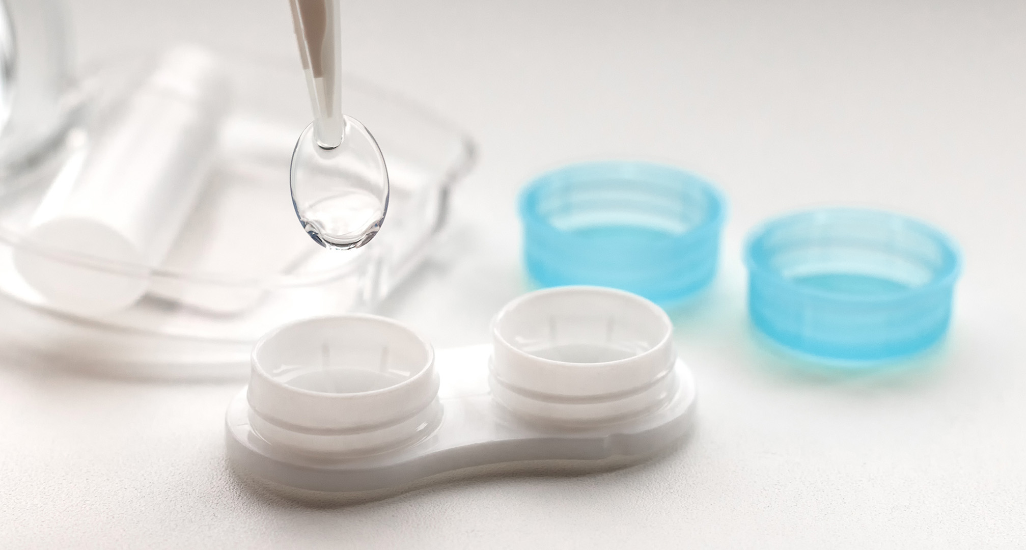 contact lens case and one contact lens on white table