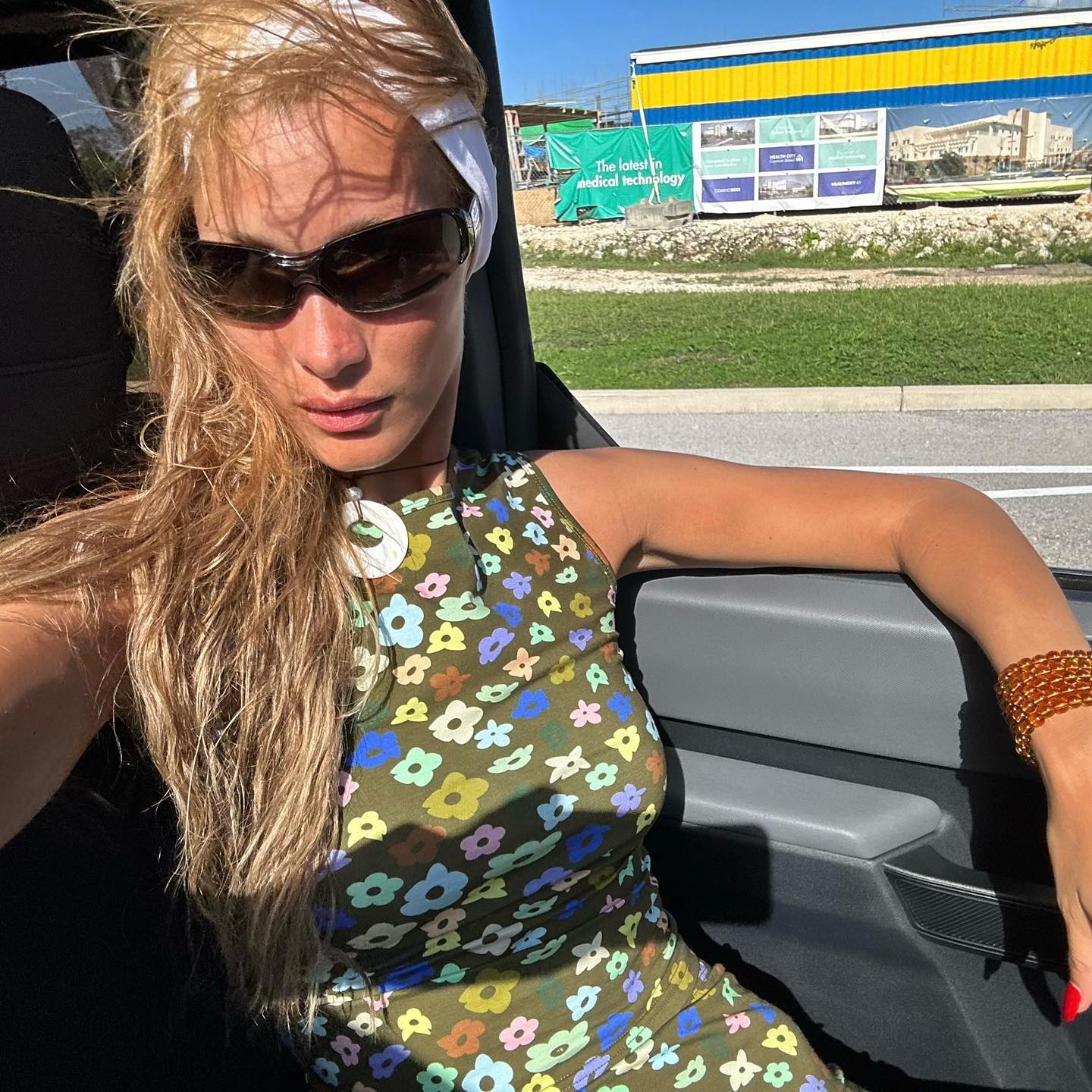bella hadid in sport sunglasses riding in car